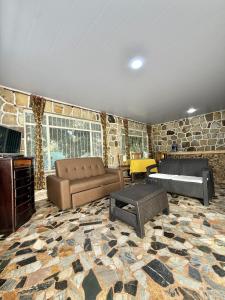 a living room with a couch and a table at Cabañas El Itali in Fusagasuga