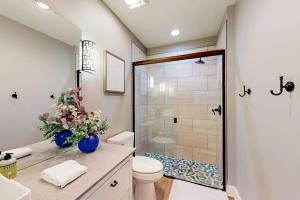 a bathroom with a shower and a toilet and a sink at Bentonvilla in Bentonville +18 photos