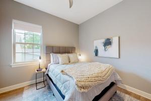 a bedroom with a large bed and a window at Bentonvilla in Bentonville