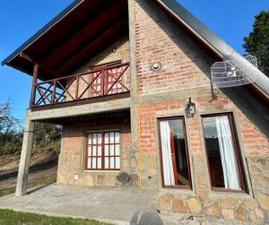 a brick house with a balcony on top of it at Selene Malen 5 in Villa Pehuenia
