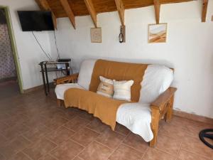 a couch sitting in a room with a tv at Selene Malen 5 in Villa Pehuenia