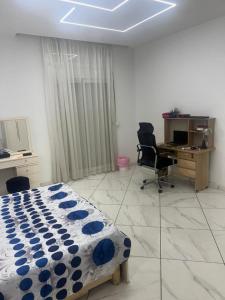 a bedroom with a bed and a desk with a computer at Oran Choupot boulevard principale in Oran
