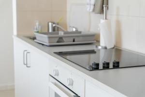 a kitchen with a sink and a counter top at Casa Rosa Panoramic Seaview in Lagoa +40 photos