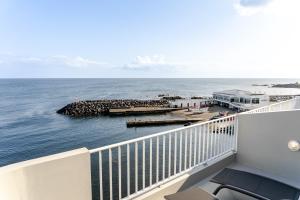 a balcony with a view of the ocean at Casa Rosa Panoramic Seaview in Lagoa