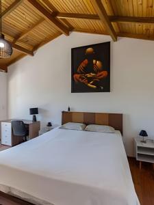 a bedroom with a large white bed in a room at Chalés da Guarda do Embaú in Guarda do Embaú +181 photos