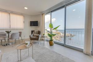 a living room with a view of the ocean at Casa Rosa Panoramic Seaview in Lagoa