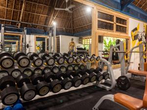 a gym with a large rack of dumbbells at Isla Bonita Zanzibar Beach Resort in Matemwe