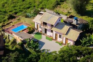 an aerial view of a house with a swimming pool at Chalés da Guarda do Embaú in Guarda do Embaú