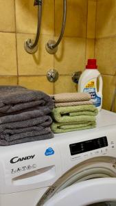 a pile of towels sitting on top of a washing machine at Lime by Kotor in Muo
