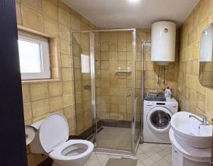 a bathroom with a toilet and a sink and a washing machine at Lime by Kotor in Muo +32 photos