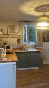a kitchen with a sink and a counter top at Le Nid de Lou in Aire +7 photos