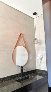 a mirror on a wall in a bathroom at Pousada Veredas da Canastra in Delfinópolis