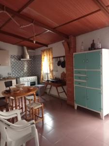 a kitchen with a table and a dining room at Casa de los Abuelos in Cardeña
