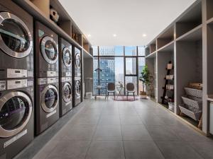 a laundry room with multiple washers and dryers at Mercure Chengdu Chunxi Taikoo Li -Walk to Pedestrian Street in Chengdu