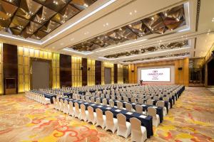 a large room with rows of chairs in front of a screen at Crowne Plaza Taizhou by IHG in Taizhou