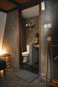 a bathroom with a toilet and a sink at Ranasa Yogyakarta in Yogyakarta +38 photos