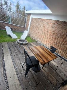 a patio with a bench and a table and chairs at Hotel Lido in General Rodríguez