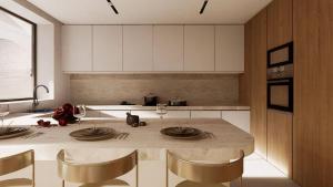 a kitchen with a table with chairs and a counter top at Lisavet Skala Kefalonia - Emerald Home Beachfront in Valsamáta