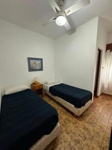 a bedroom with two beds and a ceiling fan at Hotel San Jose in Federación