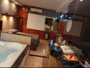 a bathroom with a bath tub and a sink at Hotel Lido in General Rodríguez +34 photos