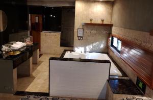 a bathroom with a large tub and a sink at Hotel Lido in General Rodríguez