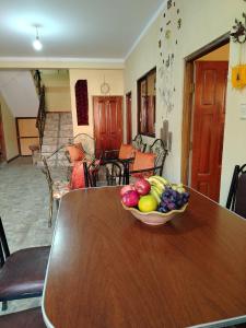 a bowl of fruit on a wooden table in a living room at Villa Bella Copacabana in Copacabana