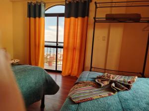 a bedroom with two bunk beds and a window at Villa Bella Copacabana in Copacabana