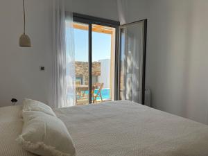 a bedroom with a bed with a view of the ocean at 2-bedroom villa Odysseus in Antiparos