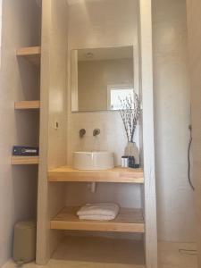 a bathroom with a sink and a mirror at 2-bedroom villa Odysseus in Antiparos +5 photos