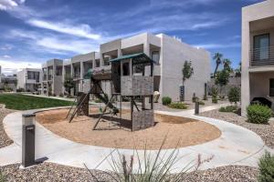 a playground in front of a building at Poolside Retreat - King Beds - Dog Friendly in St. George