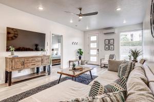a living room with a couch and a tv at Poolside Retreat - King Beds - Dog Friendly in St. George