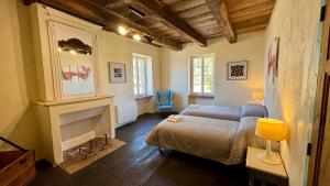 a living room with a couch and a fireplace at Les Vieilles Planches in Pampelonne