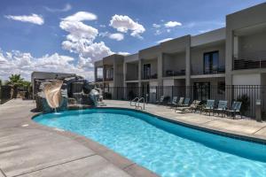 a swimming pool at a resort with a fountain at Poolside Retreat - King Beds - Dog Friendly in St. George