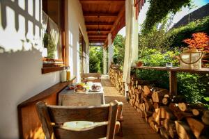 a table and chairs on a porch with a meal on it at Bambuszkert in Kisoroszi