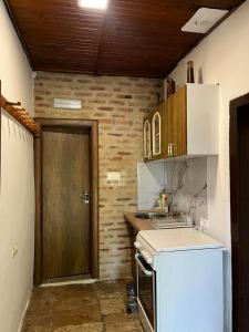 a kitchen with a sink and a wooden door at Old lake house in Nikšić