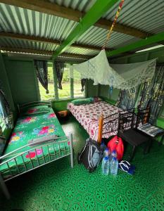 a bedroom with two beds in a tent at Navi Homestay in Naisisili