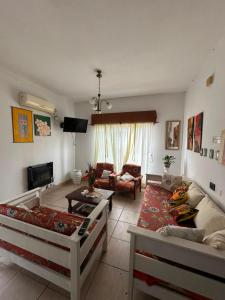 a living room with two beds and a couch at Hotel San Jose in Federación +12 photos