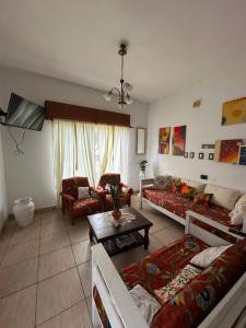 a living room with two couches and a table at Hotel San Jose in Federación