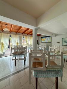 a dining room with white tables and chairs at Hotel San Jose in Federación