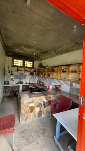 a large kitchen with a large stone counter top at Bagh Rustum Guest House in Holshāl
