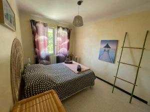 a bedroom with a bed and a window at CHEZ NATH ET STEPH in Le Grau-dʼAgde