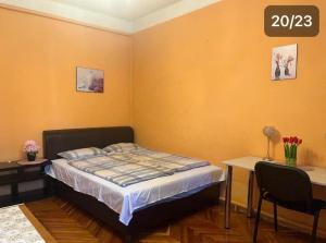 a bedroom with a bed and a table and chairs at Rose Garden in Siófok