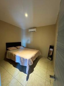 a bedroom with a bed in the corner of a room at Departamento #3 in San Carlos