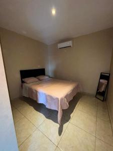 a bedroom with a bed in the corner of a room at Departamento #3 in San Carlos