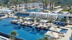 an aerial view of a hotel pool with chairs and umbrellas at Regent Porto Montenegro in Tivat