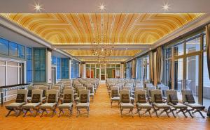 a large room with rows of chairs in a building at Regent Porto Montenegro in Tivat +233 photos