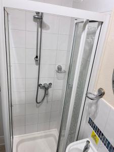 a bathroom with a shower and a toilet and a sink at Seaview Inn in Southport +33 photos