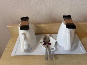 two white shoes and a pair of scissors on a plate at Seaview Inn in Southport