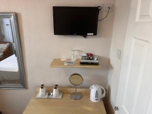 a room with a tv on the corner of a room at Seaview Inn in Southport