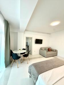 a bedroom with a bed and a table and a couch at Amira Residence in Eforie Nord